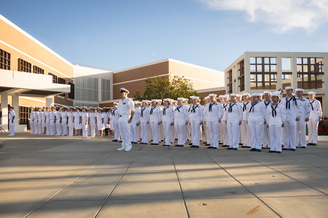 U.S. Navy Sailors stand at attention during a command dress whites inspection at the Robert E. Bush Naval Hospital, Marine Corps Air-Ground Combat Center, Twentynine Palms, California, April 19, 2024. The inspection is conducted annually in preparation for the Navy’s seasonal uniform change. (U.S. Marine Corps photo by Lance Cpl. Enge You)