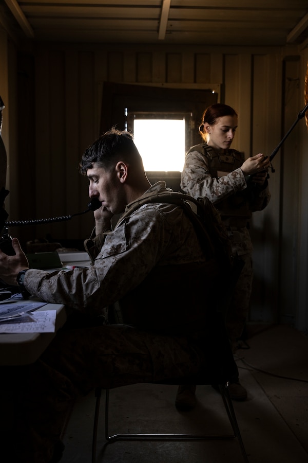 U.S. Marine Corps 2nd Lt. Matthew Smith, a Corpus Christi, Texas native, left, and 2nd Lt. Fiona Lyle, a Monroe, Washington native, both students with Marine Corps Communication-Electronics School, Training and Education Command, test radio capabilities during Basic Communications Officer Course 1-24, oat range 225, Marine Corps Air-Ground Combat Center, Twentynine Palms, California, May 1, 2024. During the BCOC students learn about signal modulation, basic electrical concepts, and how to build field expedient antennas. (U.S. Marine Corps photo by Cpl. Hunter Wagner)