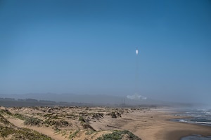A rocket launches from a launch pad.