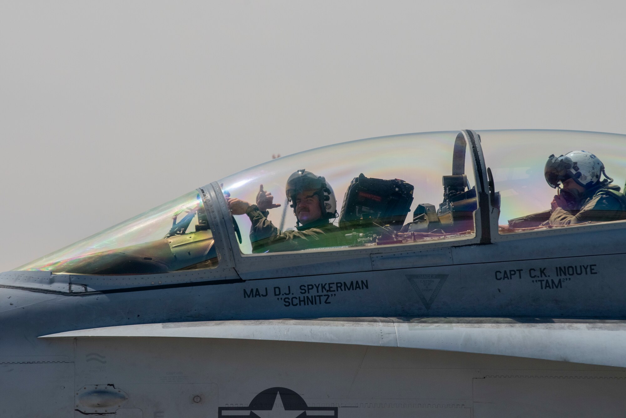 U.S. Navy officers sitting in the cockpit of an EA-18G electronic warfare jet