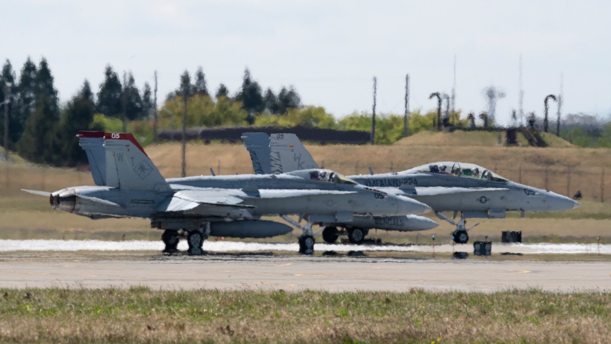 Two U.S. Marine Corps F/A-18 fighter jets prepare to take off during a readiness exercise