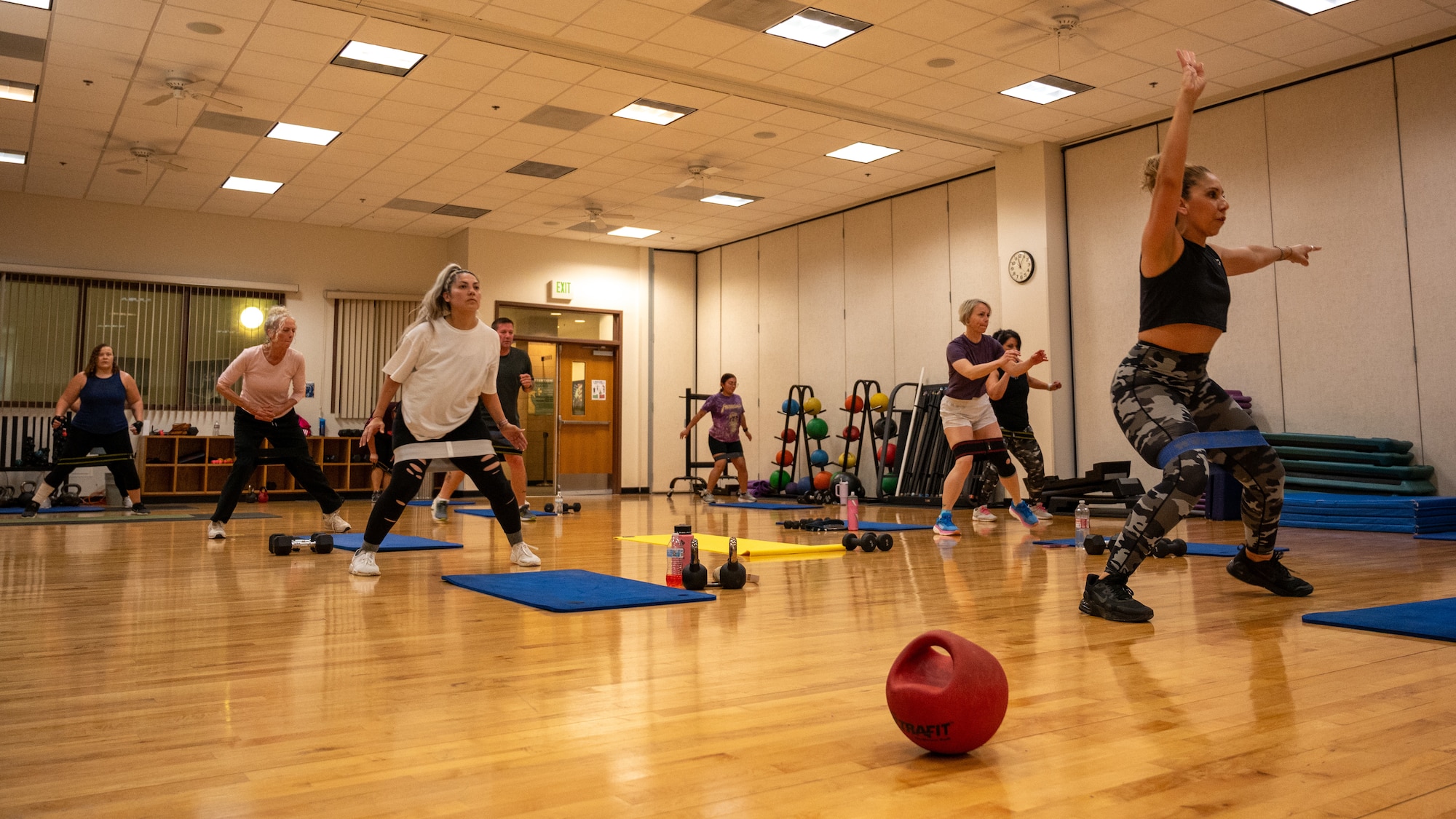 Airmen run through a fitness class led by Ms. Poloma Felan in the Losano Fitness Center at Laughlin Air Force Base, Texas, April 25, 2024. Structured fitness classes are an excellent way for Airmen to stay in shape, being led through a measured workout by an instructor. (U.S. Air Force photo by Staff Sgt. Nicholas Larsen)