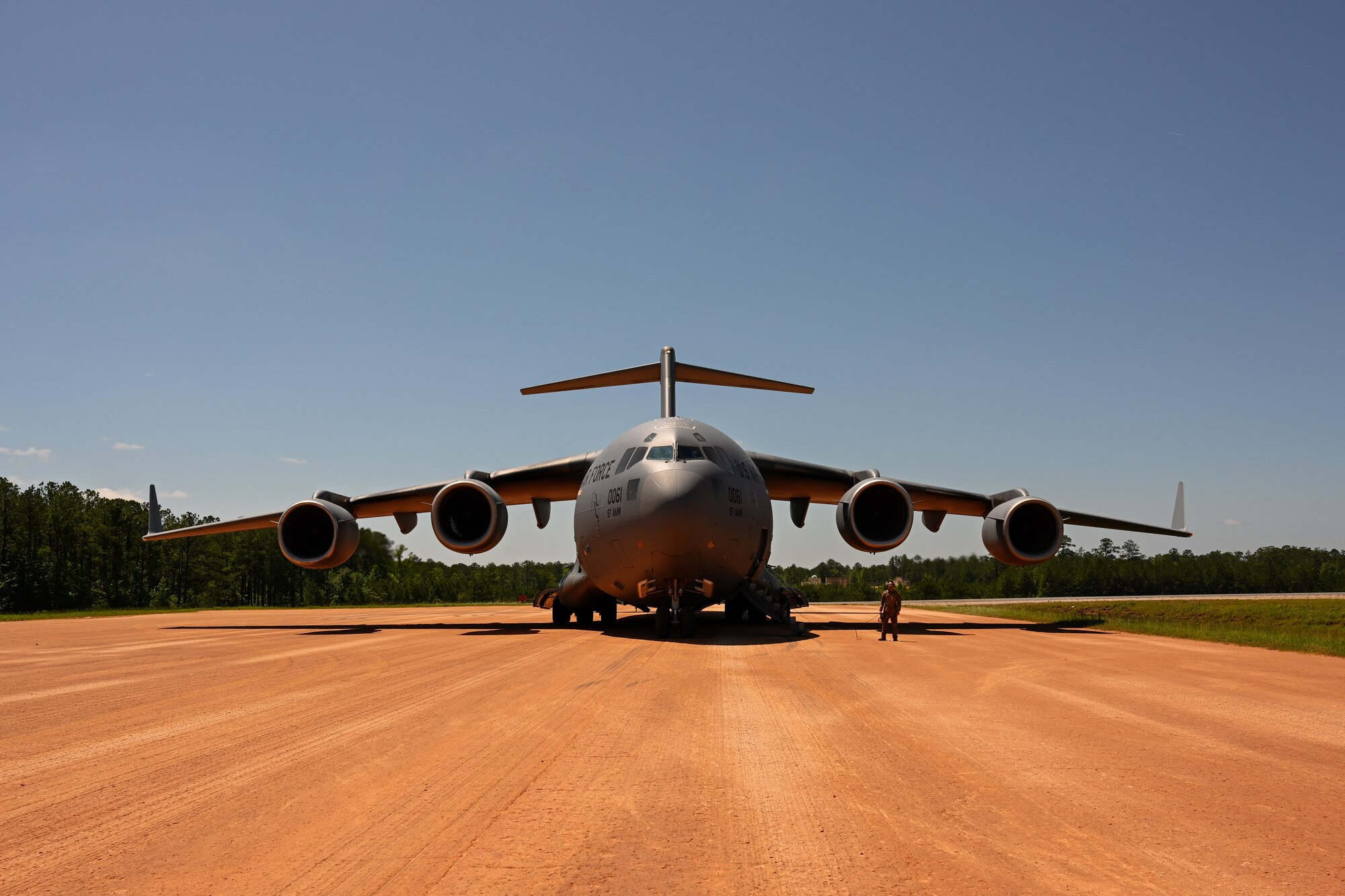 A C-17 Globemaster III aircraft assigned to the 97th Air Mobility Wing on a semi-prepared runway at Fort Johnson, Louisiana, April 30, 2024. The C-17 can take off and land on runways as short as 3,500 feet long and 90 feet wide. (U.S. Air Force Photo by Airman 1st Class Jonah G. Bliss)