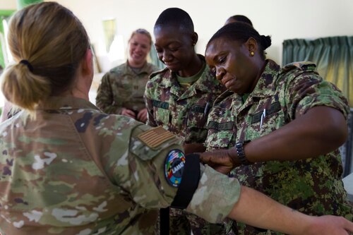 Image of a service member treating a patient.