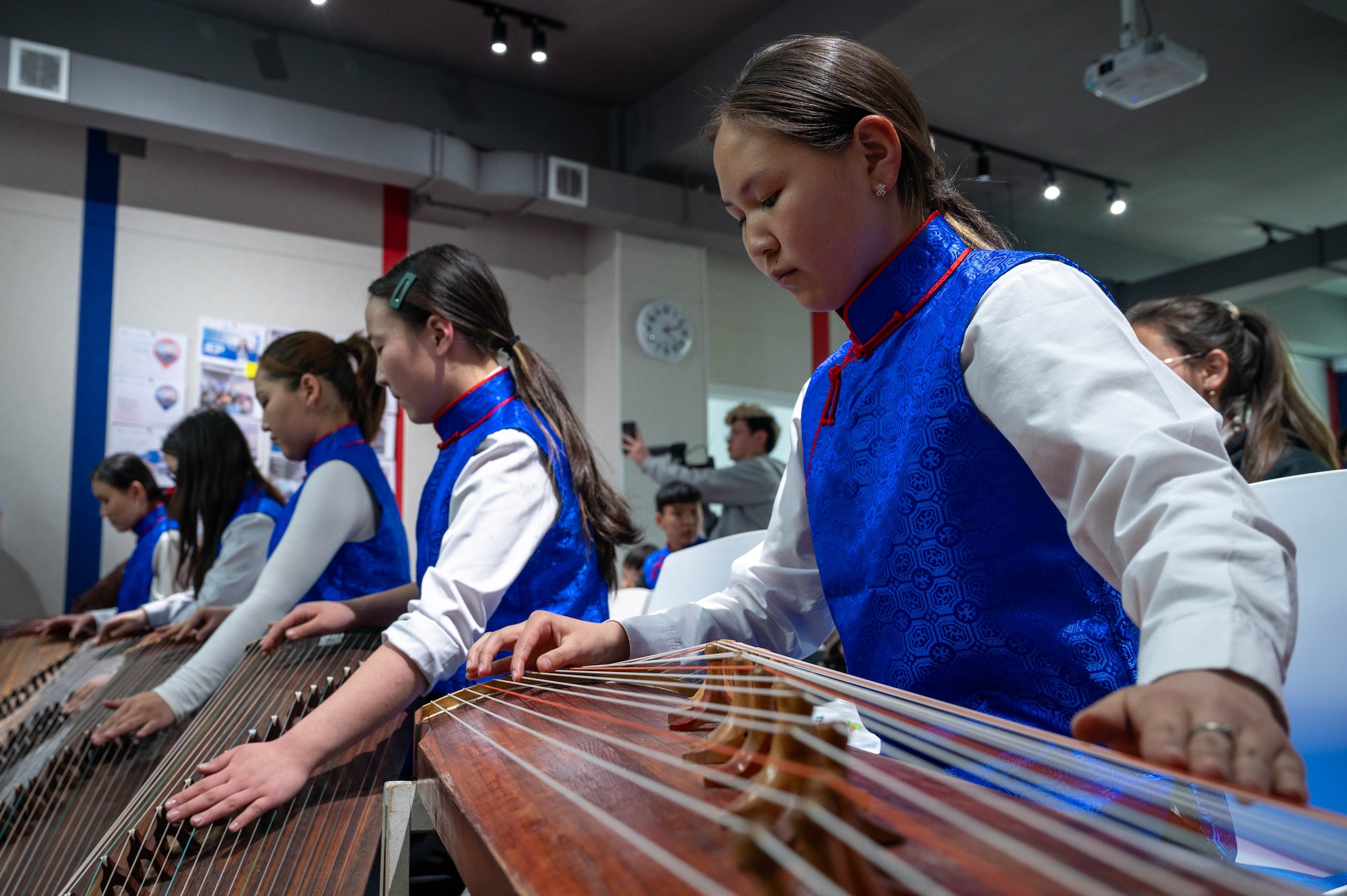 Students play instruments.
