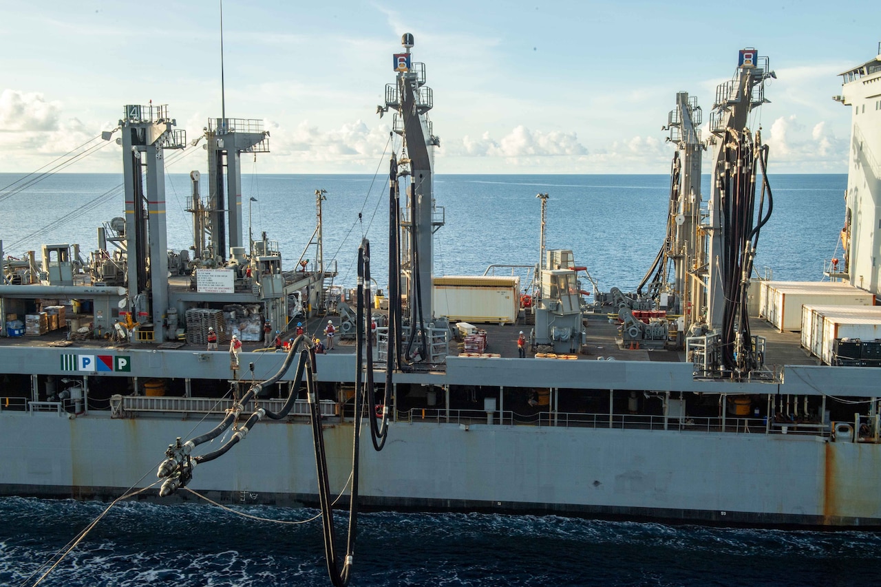 A fuel hose connects to a ship.