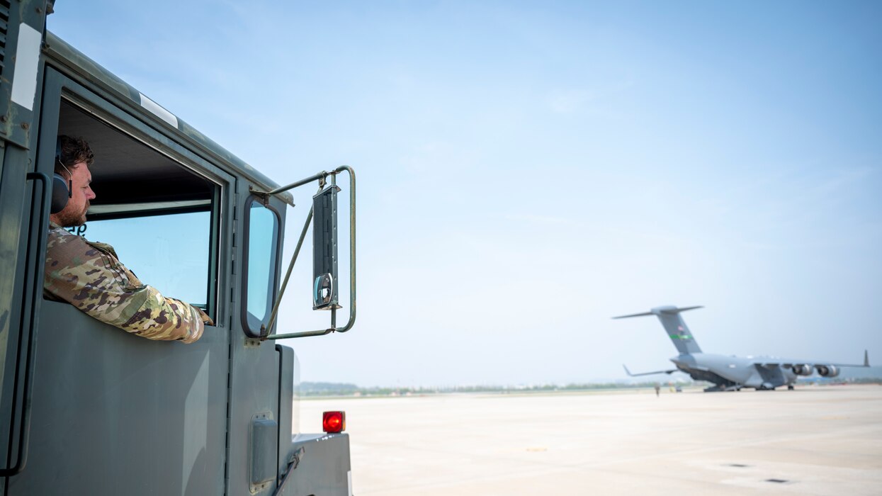 U.S. Air Force Staff Sgt. Chandler Chase, 51st Logistics Readiness Squadron training supervisor, prepares to conduct a wet-wing defuel operation with a U.S. Air Force C-17 Globemaster III at Osan Air Base, Republic of Korea, April 19, 2024. The 51st LRS conducted the first-ever wet-wing defuel operation at the AB. The operation removes fuel from an aircraft while its engines are running, enabling aircraft to quickly return to the mission. (U.S. Air Force photo by Senior Airman Sabrina Fuller-Judd)