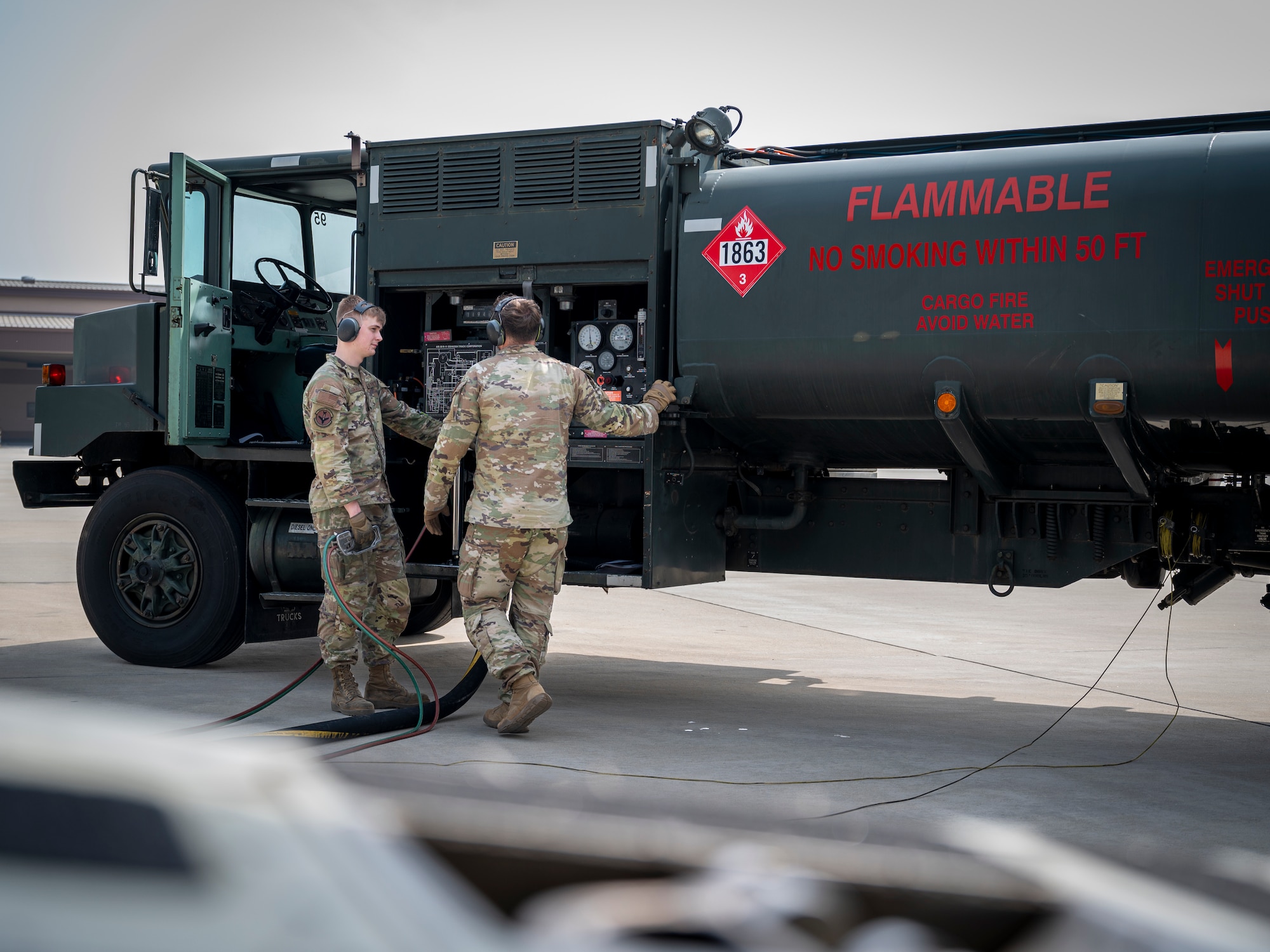 U.S. Air Force Staff Sgt. Chandler Chase, right, 51st Logistics Readiness Squadron training supervisor and Senior Airman Adam Goebel, 51st LRS distribution operator, monitor defuel operations at Osan Air Base, Republic of Korea, April 19, 2024. The 51st LRS completed the inaugural wet-wing defuel at Osan AB. The operation removed fuel from an aircraft while the engines were running in order to decrease aircraft ground time, ensuring efficient executions of missions. (U.S. Air Force photo by Senior Airman Sabrina Fuller-Judd)