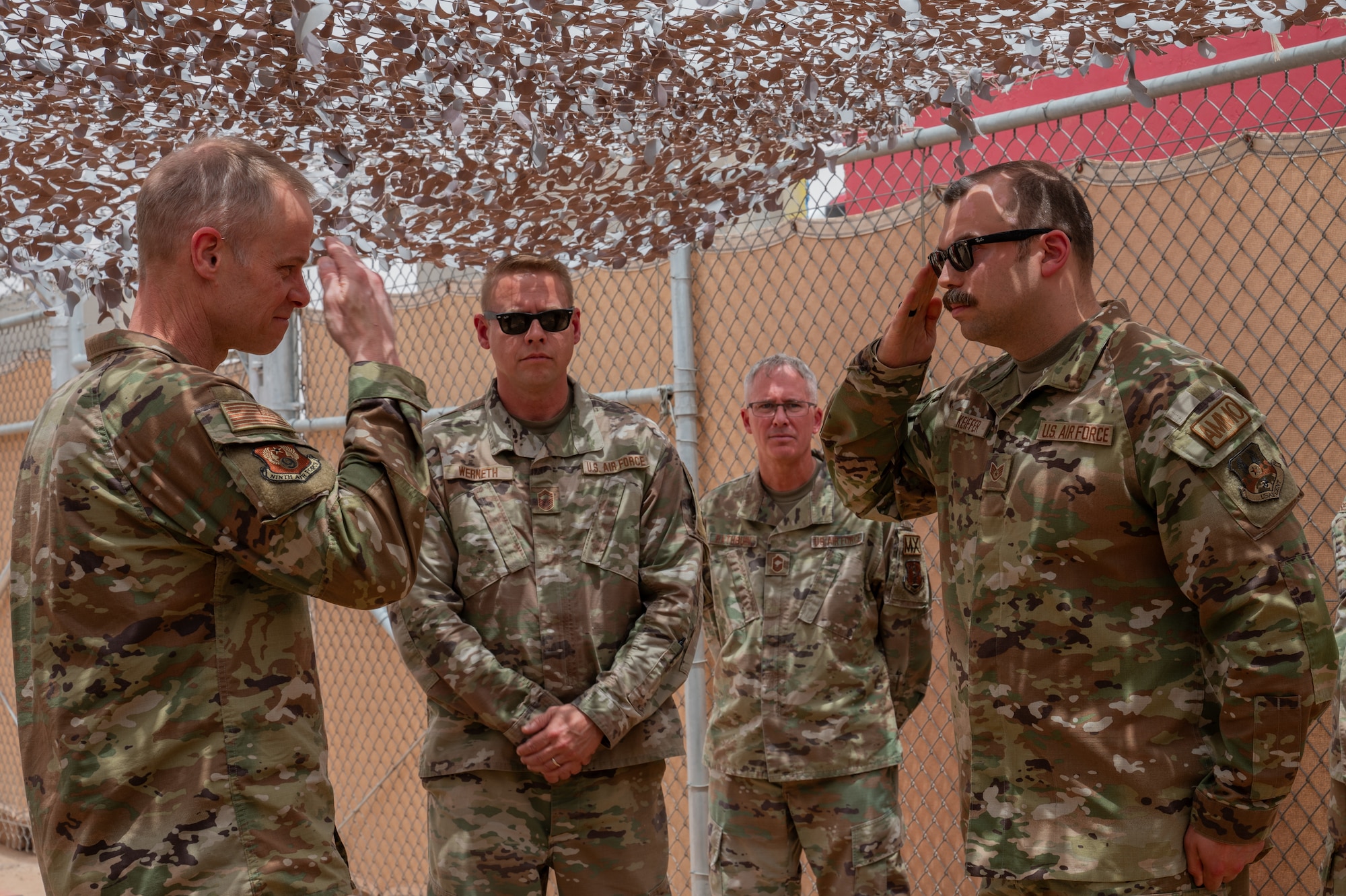 Airman saluting Lt. Gen. France