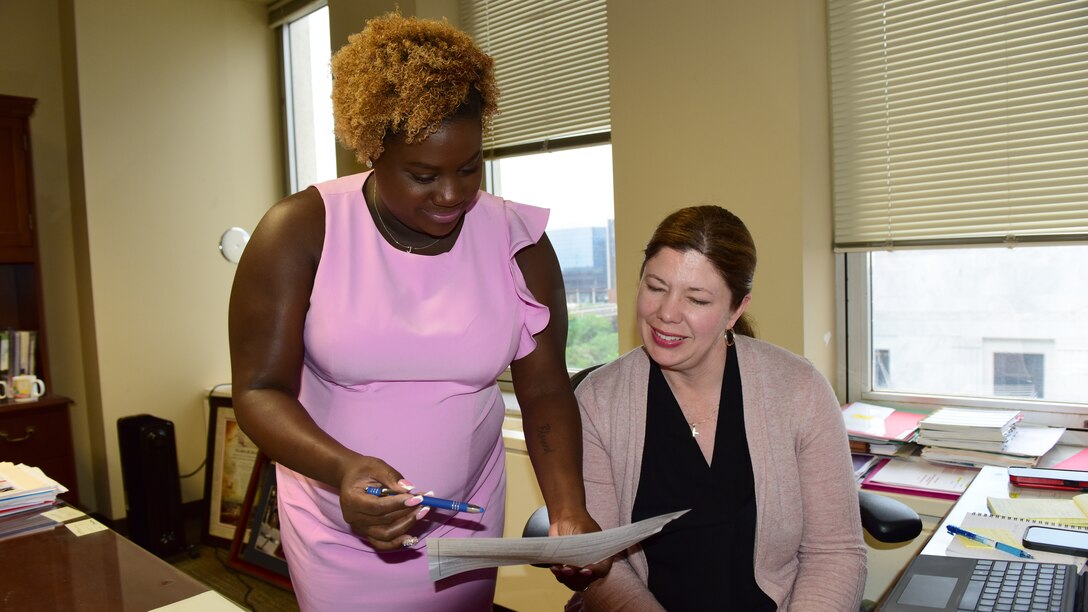 Jasmine Watson, administrative professional in the U.S. Army Corps of Engineers Nashville District Integrated Project Office, provides an equipment inventory update May 7, 2024, with Elizabeth Burks, IPO chief, at the office in Nashville, Tennessee. (USACE Photo by Lee Roberts)