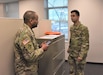 Pvt. Basar Findikl (right), motor transport operator, HHC, 653rd Regional Support Group, listens to instructions from Sgt. Johnathan Stone, HHC, 653rd RSG, Feb. 25, Armed Forces Reserve Center, Mesa, Ariz., as part of Battle Assembly weekend for the unit. (U.S. Army Reserve Photo by Maj. Alun Thomas, 653rd RSG Public Affairs)