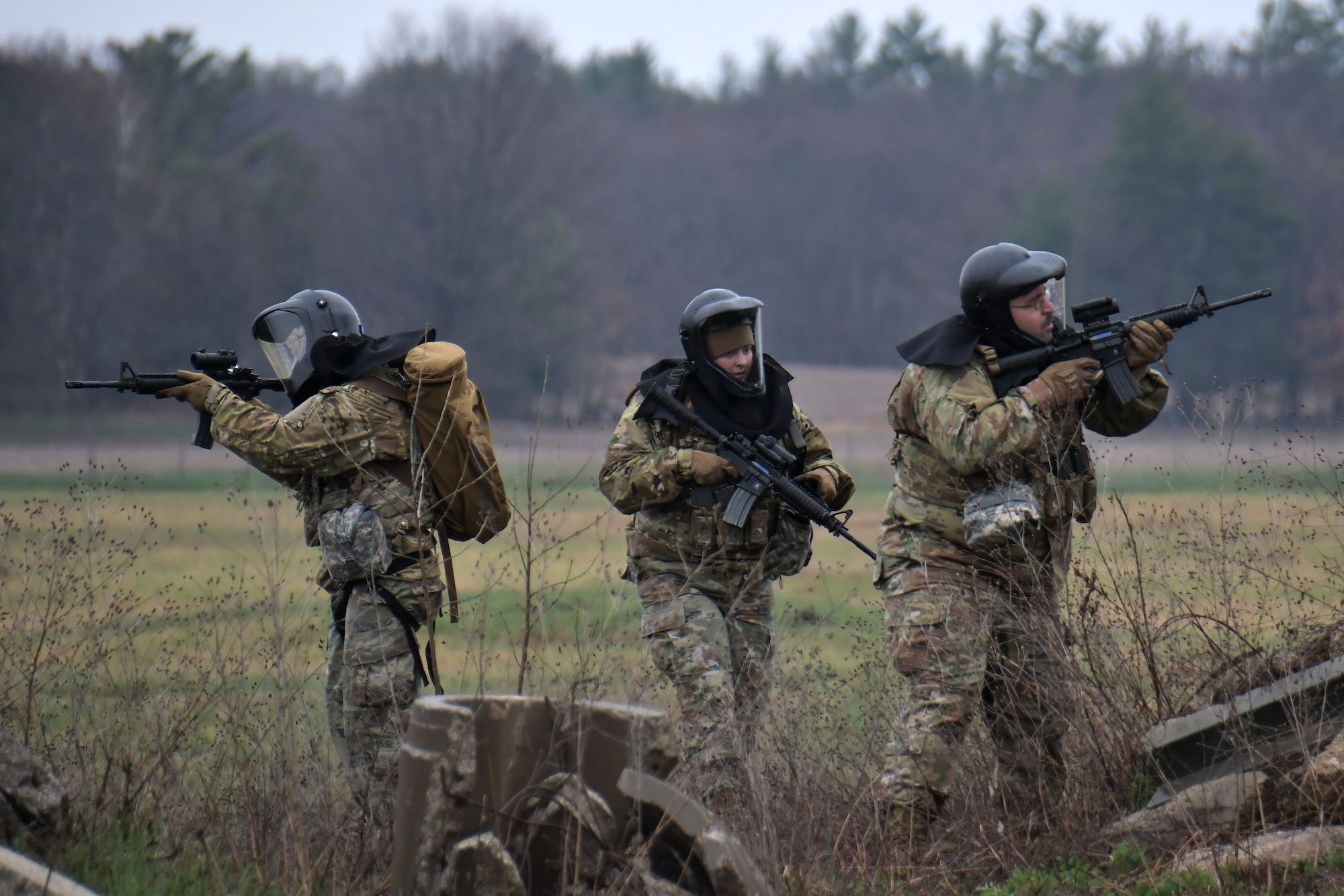 U.S. Air Force security forces and explosive ordnance disposal specialists assigned to the Wisconsin Air National Guard's 115th Fighter Wing engage threats during a tactical combat casualty care scenario April 18, 2024, at Volk Field Air National Guard Base near Camp Douglas, Wisconsin. TCCC implements proven medical practices in battlefield trauma care and provides basic lifesaving techniques to wounded personnel, substantially increasing battlefield survivability. (U.S. Air National Guard photo by Senior Master Sgt. Paul Gorman)