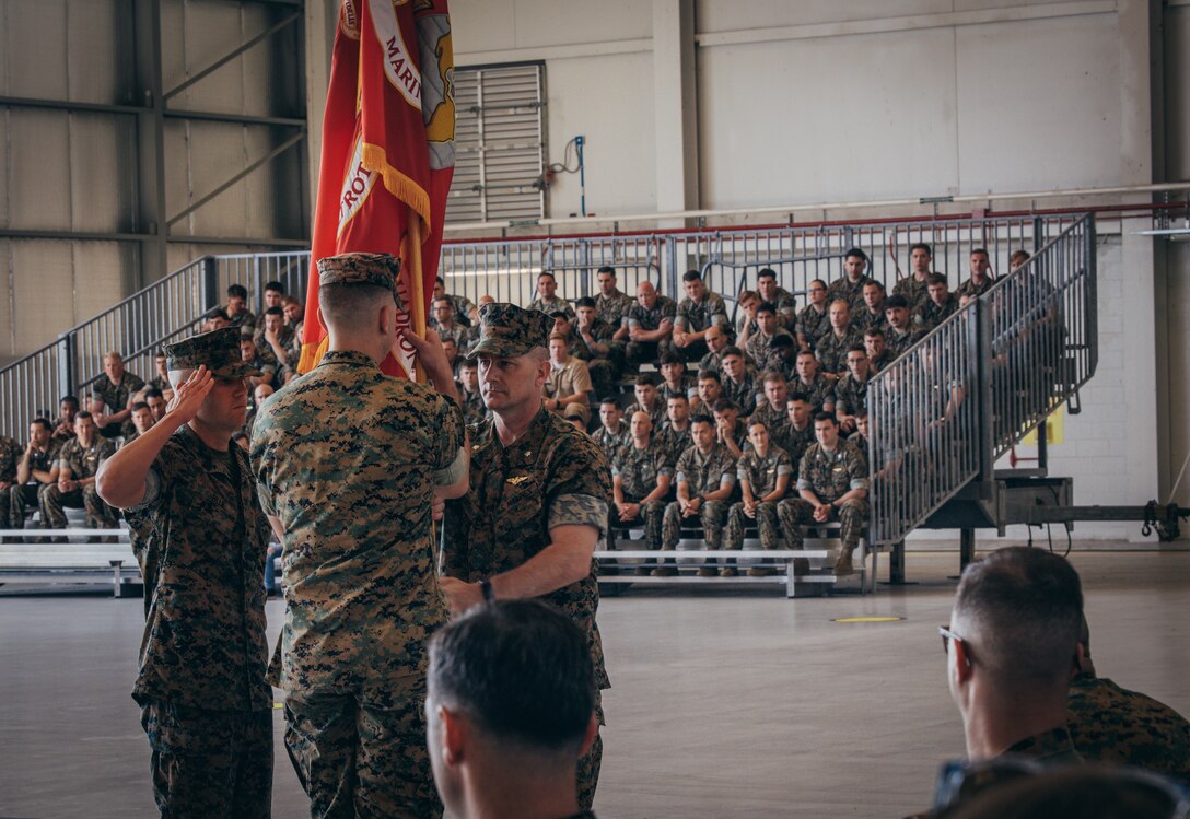 U.S. Marine Corps Lt. Col. Larry Buzzard, outgoing Commanding Officer of Marine Medium Tiltrotor Squadron (VMM) 162 (Reinforced), 26th Marine Expeditionary Unit (Special Operations Capable) passes the Marine Corps flag to Lt. Col. Carles D. Jordan during the squadron’s change of command ceremony at Marine Corps Air Station New River, North Carolina, May 2, 2024. The passing of command signifies the transfer of responsibility, authority and accountability from the outgoing commanding officer to the oncoming commanding officer. (U.S. Marine Corps photo by Cpl. Aziza Kamuhanda)
