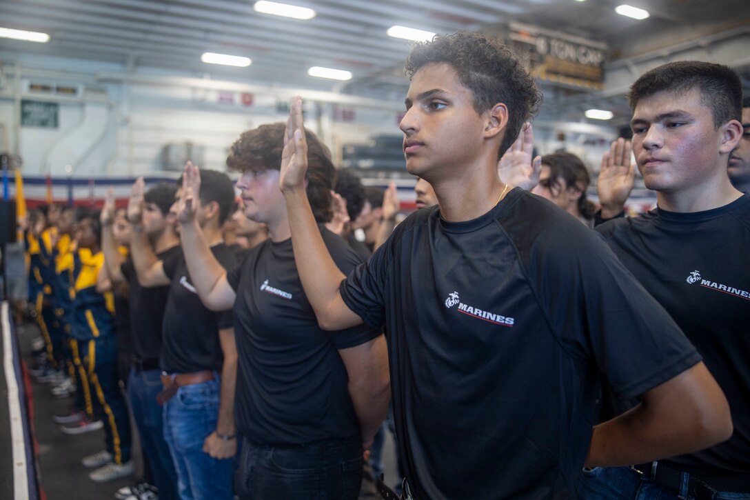 Future U.S. Marines and Sailors recite the oath of enlistment while aboard the amphibious assault ship USS Bataan (LHD 5) as part of Fleet Week Miami at PortMiami, May 8, 2024. Fleet Weeks are a tradition of the U.S. Navy, Marine Corps and Coast Guard, where major U.S. cities host Marines, Sailors, and Coast Guardsmen for one week of community-wide events. Fleet Week Miami, in its first year, is an opportunity for residents and visitors to meet with service members, foster community relationships, and view the latest capabilities of today's maritime services. (U.S. Marine Corps photo by Cpl. Jacquilyn Davis)