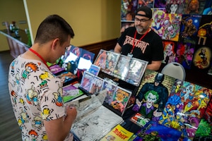 Jason Turner, illustrator and variant cover artist, sells his artwork during Keesler Con and the Eastern Regional Esports Invitational at Keesler Air Force Base, Mississippi, May 4, 2024.