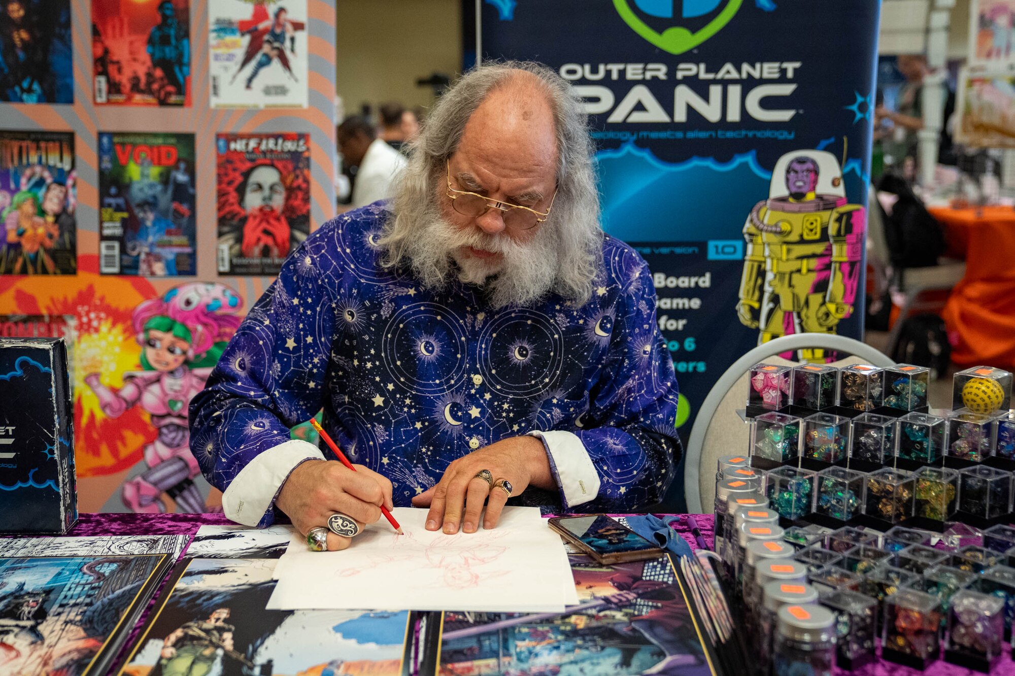 Charles Moisant, artist and writer, sketches a design during Keesler Con and the Eastern Regional Esports Invitational at Keesler Air Force Base, Mississippi, May 4, 2024.