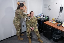 Air Force Audiologist performs exam