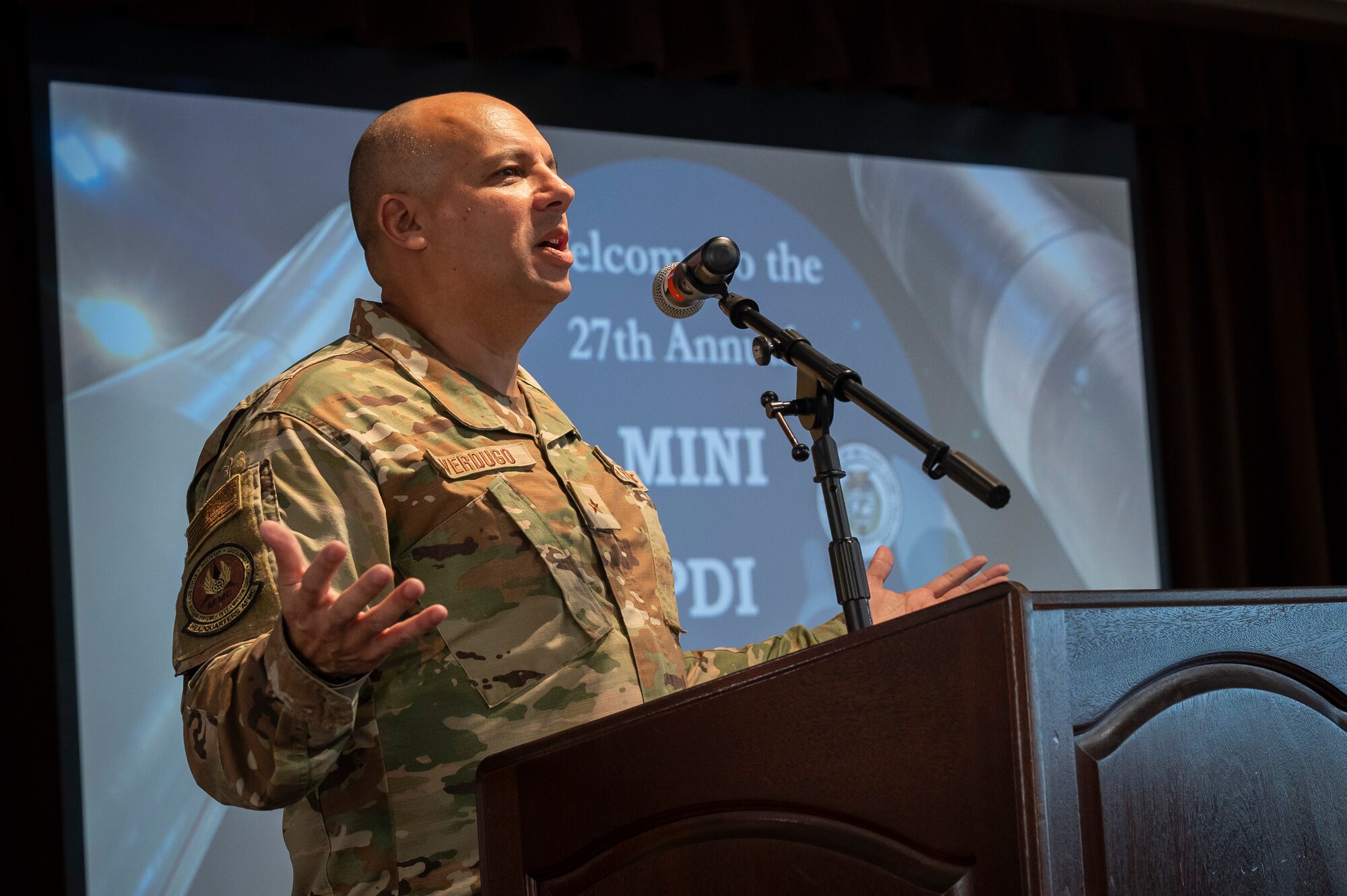 Man wearing Air Force uniform speaking at podium.