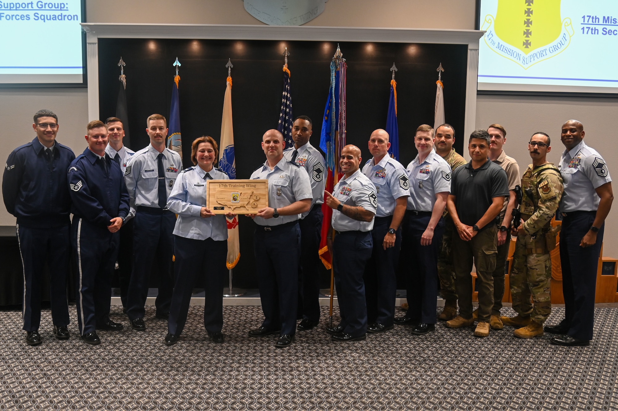 17th Security Forces Squadron defenders pose with U.S. Air Force Col. Angelina Maguinness, 17th Training Wing commander, and Chief Master Sgt. Derrick Sherrod, 17th Mission Support Group senior enlisted leader, as they receive their Unit of the Quarter award at the Powell Event Center, Goodfellow Air Force Base, Texas, May 3, 2024. Quarterly awards are a tradition that honors exceptional individuals and units for their outstanding contributions to the 17th TRW mission. (U.S. Air Force photo by Airman James Salellas)