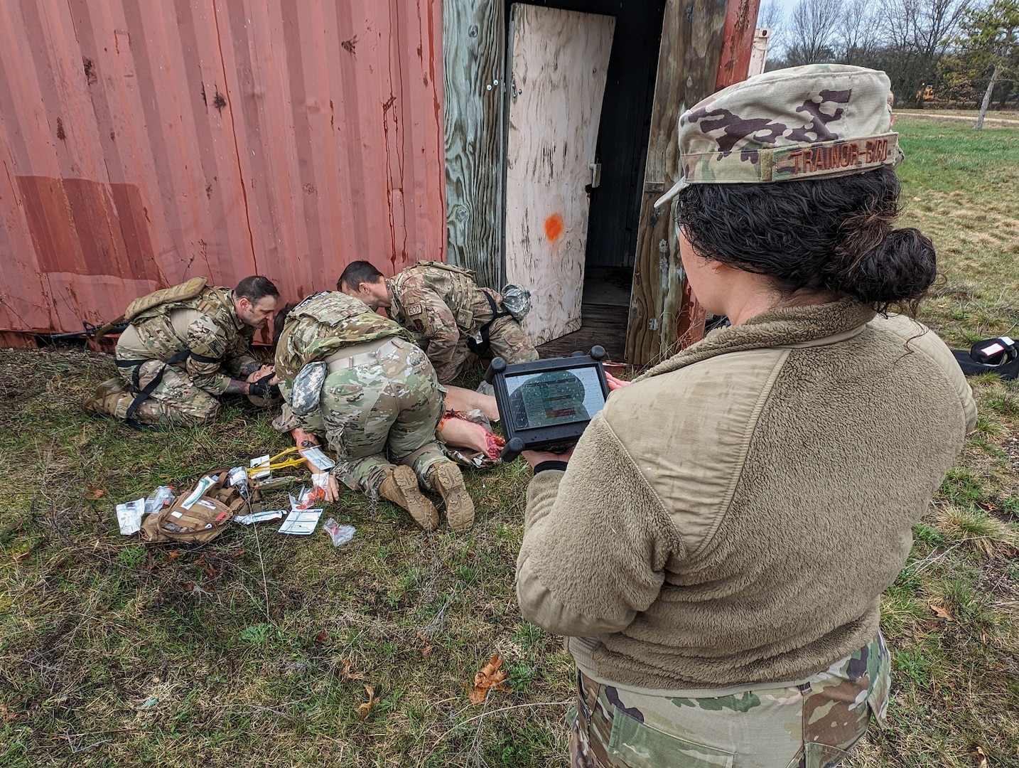 U.S. Air Force Tech. Sgt. Kailani Trainor-Bird, a medical specialist assigned to the Wisconsin Air National Guard's 115th Fighter Wing, remotely operates a tactical combat patient simulator during a tactical combat casualty care exercise April 18, 2024, at Volk Field Air National Guard Base near Camp Douglas, Wisconsin. The training exercise was part of a 40 hour Tactical Combat Casualty Care - Combat Life Savers Course administered by members of the 115th Medical Group to Airmen within the wing who's career fields require advanced lifesaving skills. (U.S. Air National Guard photo by Senior Master Sgt. Paul Gorman)