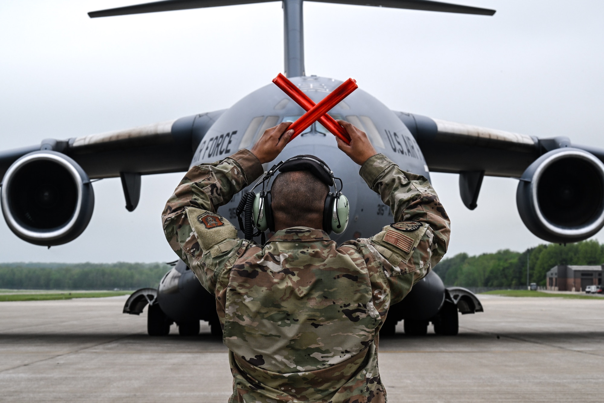 Tech. Sgt. Ian Ludy, a maintainer with the 910th Maintenance Group, marshals in a C-17 Globemaster III at Youngstown Air Reserve Station, Ohio, May 5, 2024.