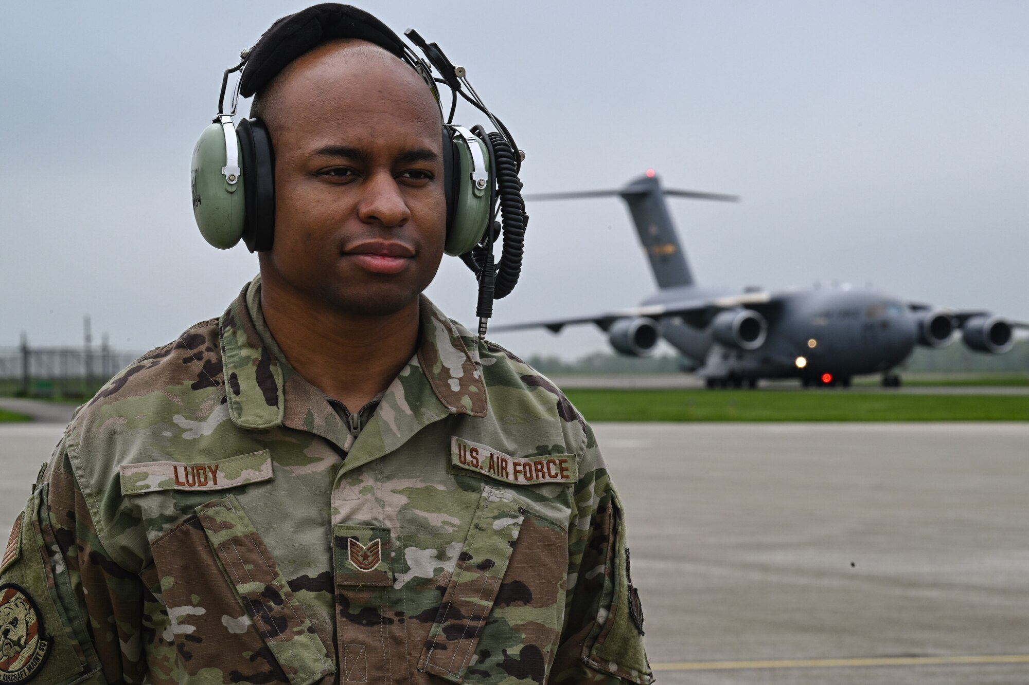 Tech. Sgt. Ian Ludy, a maintainer with the 910th Maintenance Group, waits to marshal in a C-17 Globemaster III at Youngstown Air Reserve Station, Ohio, May 5, 2024.