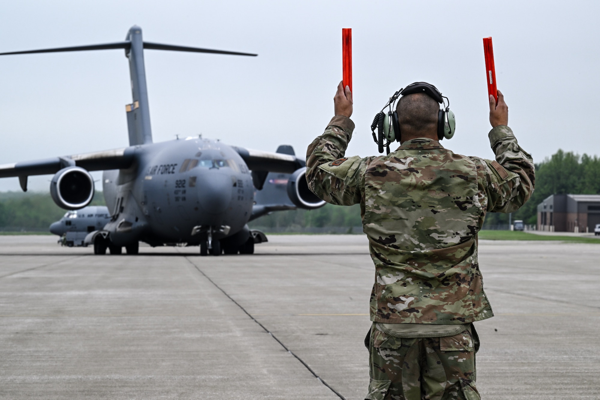 Tech. Sgt. Ian Ludy, a maintainer with the 910th Maintenance Group, marshals in a C-17 Globemaster III at Youngstown Air Reserve Station, Ohio, May 5, 2024.