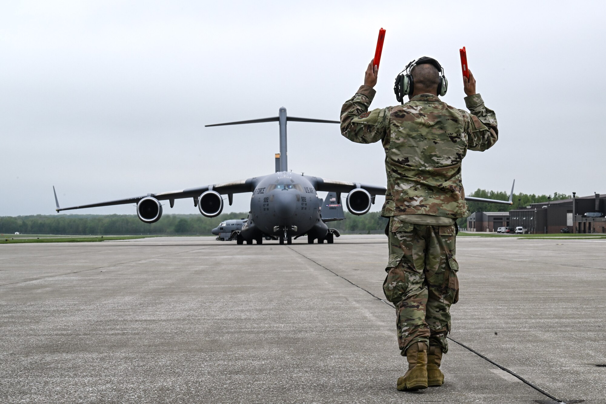 Tech. Sgt. Ian Ludy, a maintainer with the 910th Maintenance Group, marshals in a C-17 Globemaster III at Youngstown Air Reserve Station, Ohio, May 5, 2024.