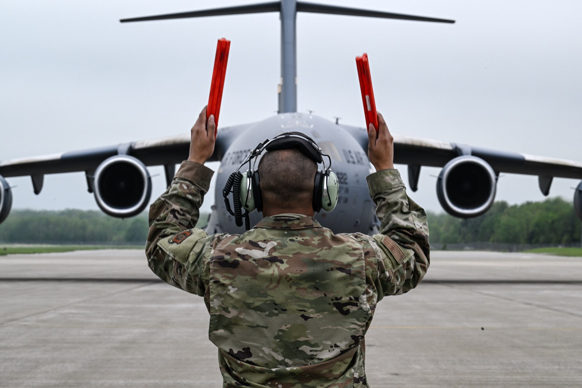 Tech. Sgt. Ian Ludy, a maintainer with the 910th Maintenance Group, marshals in a C-17 Globemaster III at Youngstown Air Reserve Station, Ohio, May 5, 2024.