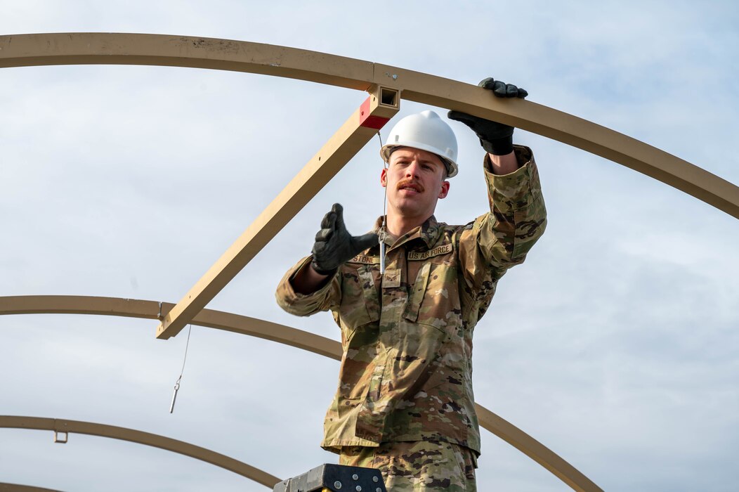 U.S. Air Force Senior Airman Caleb Stone, 354th Force Support Squadron fitness center technician, hooks a frame in for a tent during a Ready Raven Team exercise to bolster Agile Combat Employment at Eielson Air Force Base, Alaska, May 2, 2024.
