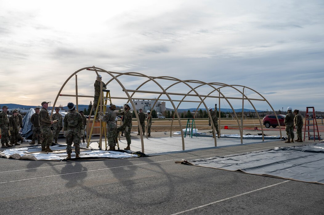 Airmen assigned to the 354th Force Support Squadron build the frame of a tent during a Ready Raven Team exercise to bolster Agile Combat Employment at Eielson Air Force Base, Alaska, May 2, 2024.