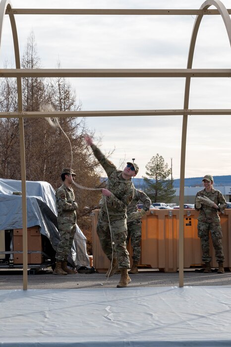 U.S. Air Force Airman 1st Class Ethan Staten, 355th Fighter Generation Squadron force management technician, throws a rope over a tent frame during a Ready Raven Team exercise to bolster Agile Combat Employment at Eielson Air Force Base, Alaska, May 2, 2024.