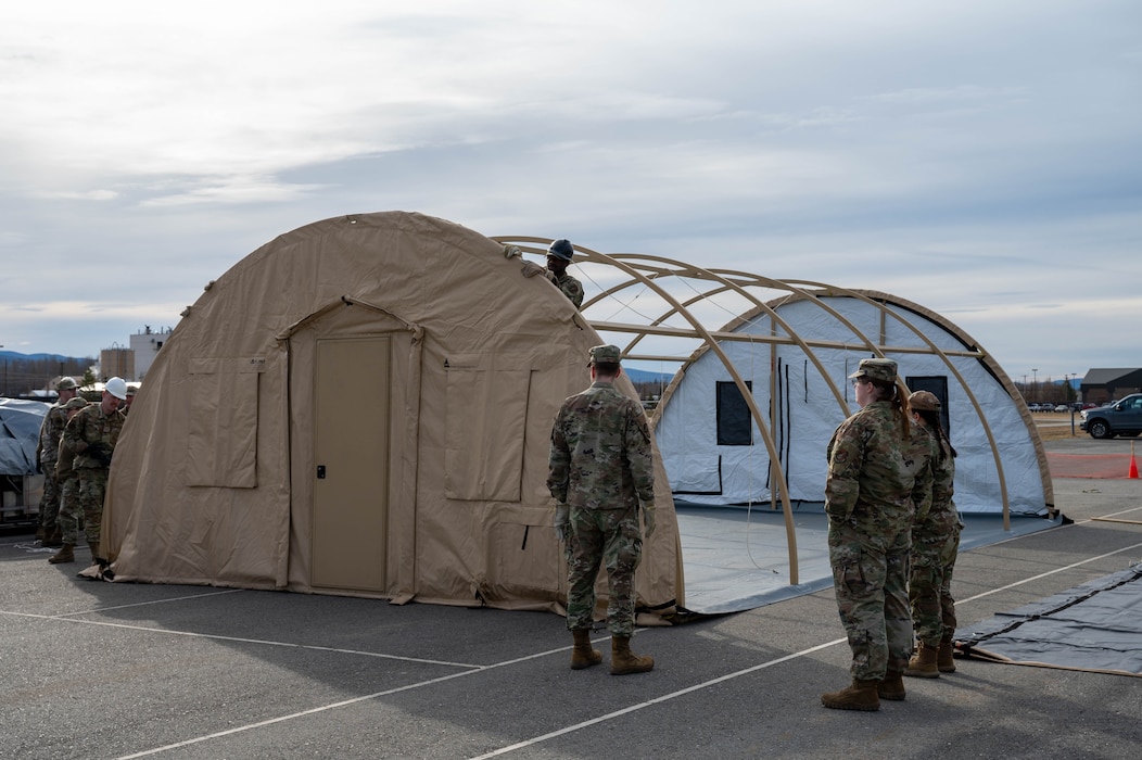 Airmen assigned to the 354th Force Support Squadron near the completion of a tent during a Ready Raven Team exercise to bolster Agile Combat Employment at Eielson Air Force Base, Alaska, May 2, 2024.