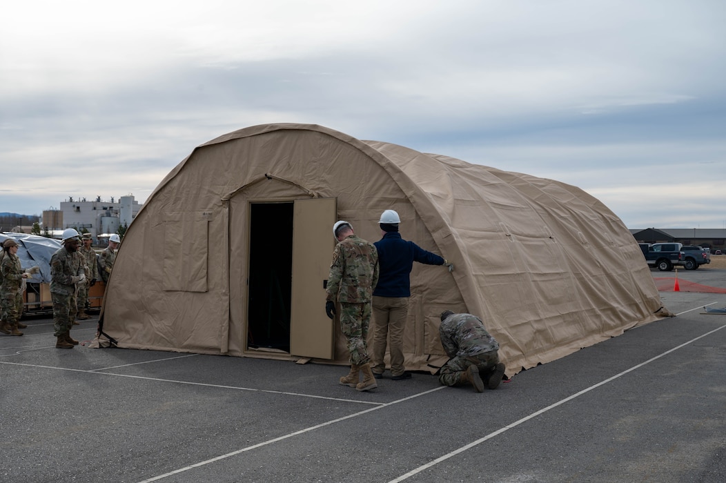 Airmen assigned to the 354th Force Support Squadron finish building a tent during a Ready Raven Team exercise to bolster Agile Combat Employment at Eielson Air Force Base, Alaska, May 2, 2024.
