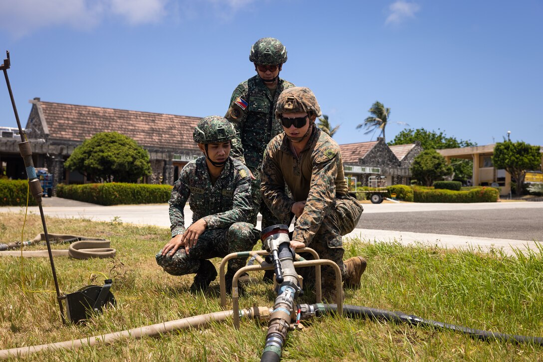 U.S. Marine Corps Cpl. Alexis Medina, an expeditionary fuel technician with Marine Wing Support Squadron 174, conducts equipment familiarization alongside Philippine Marines with Marine Battalion Landing Team 10 in support of forward arming and refueling point operations during Balikatan 24 in Basco, Batanes Province, Philippines, April 30, 2024. BK 24 is an annual exercise between the Armed Forces of the Philippines and the U.S. military designed to strengthen bilateral interoperability, capabilities, trust, and cooperation built over decades of shared experiences. (U.S. Marine Corps photo by Sgt. Jennifer Andrade)