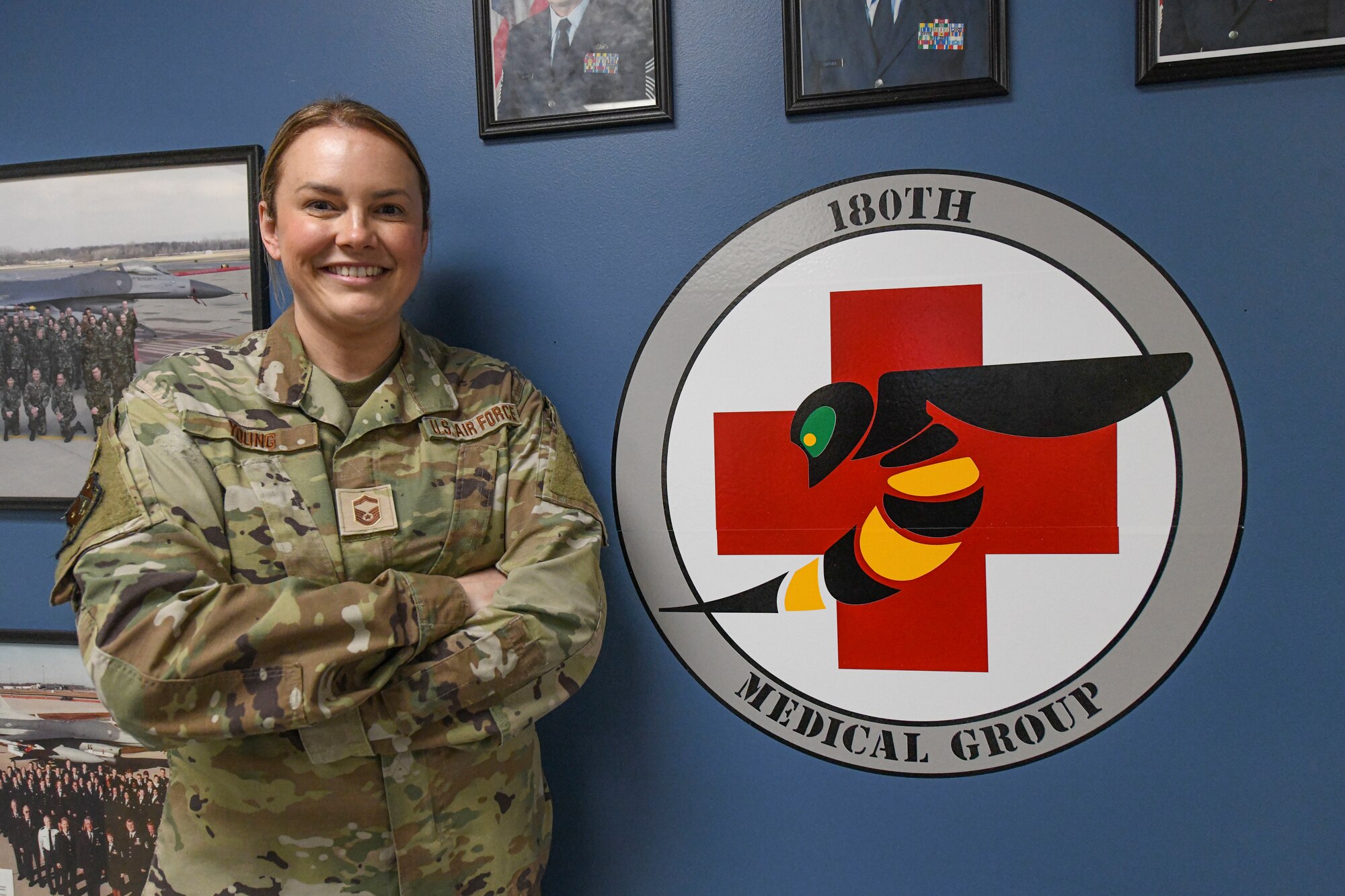 A woman poses in front on medical equipment.