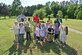Attendees of the Arbor Day celebration pose for a group picture at Heritage Park on April 24, 2024, at Columbus Air Force Base, Mississippi, with one of the trees planted for the event. The first Arbor Day took place in 1874 in Nebraska, resulting in over 1 million trees planted across the United States. (U.S. Air Force Photo by 2nd Lt. Douglas Armstrong)