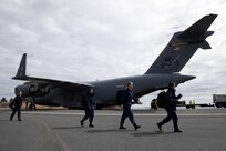Members of the U.S. Public Health Service offload from an Alaska Air National Guard C-17 Globemaster III assigned to the 144th Airlift Squadron, 176th Wing, during Kodiak Arctic Care 24 Innovative Readiness Training Mission at Kodiak, Alaska, May 6, 2024.