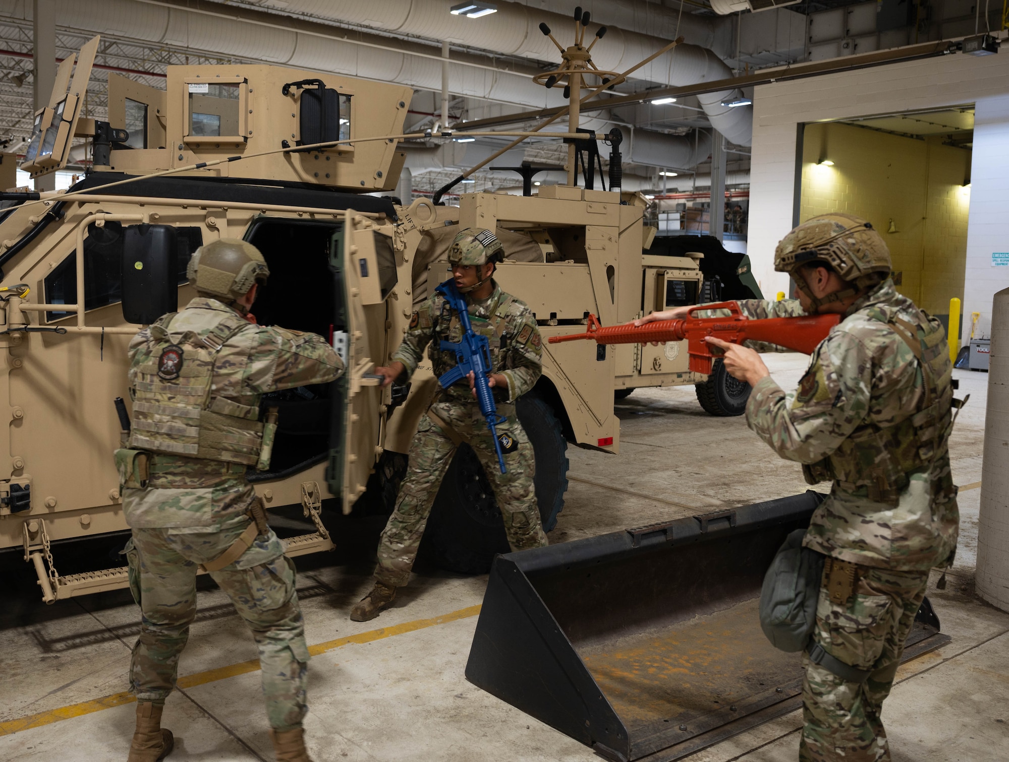 Defenders assigned to the 5th Security Forces Squadron (5th SFS) search a humvee as part of an active shooter drill during Warbird Week at Minot Air Force Base, North Dakota, May 7, 2024. This real-life scenario tested the 5th SFS readiness and response. (U.S. Air Force photo by Airman 1st  Class Luis Gomez)