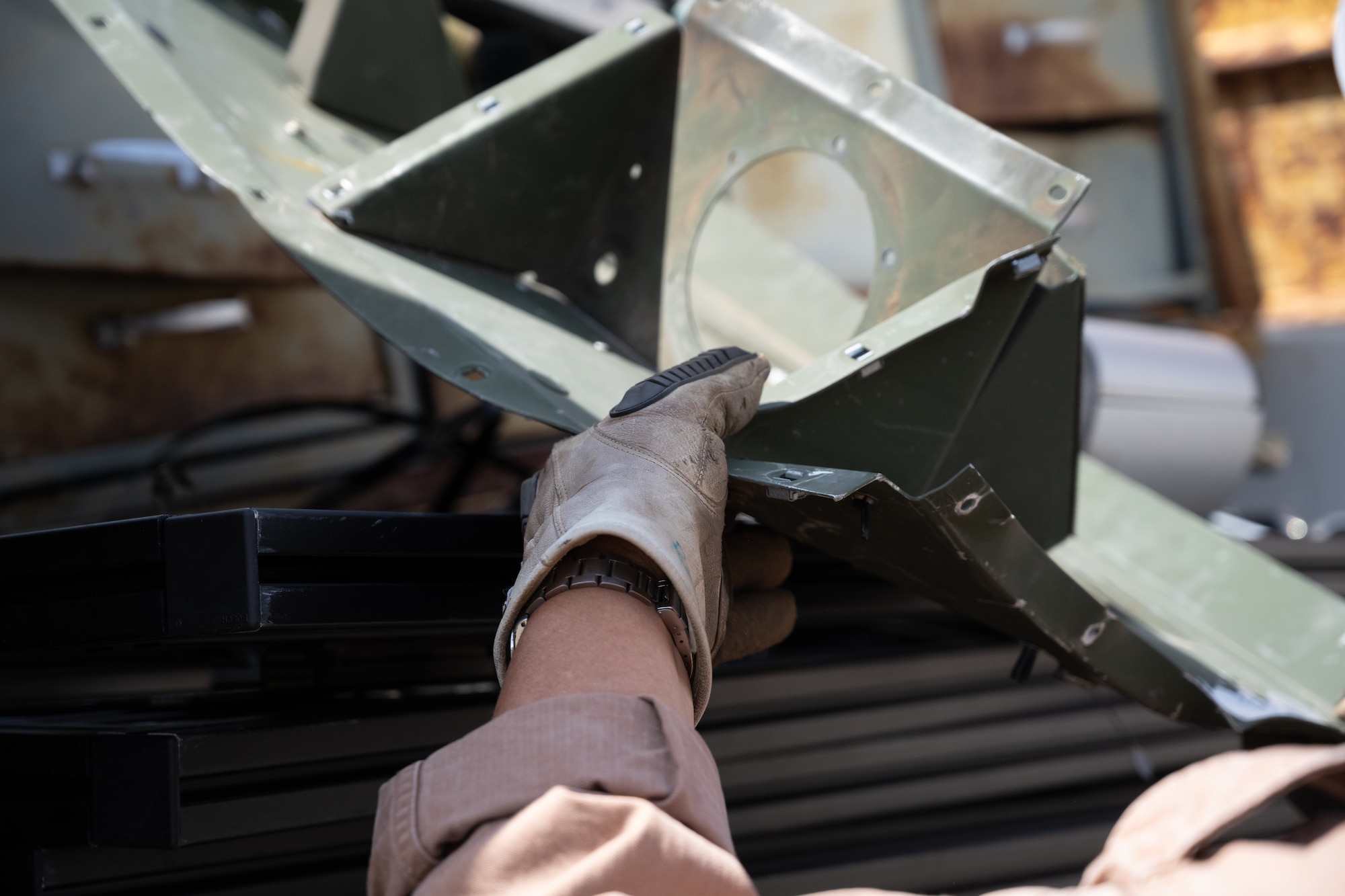 Ronald Tolentino  loads scrap metal into a holding container.