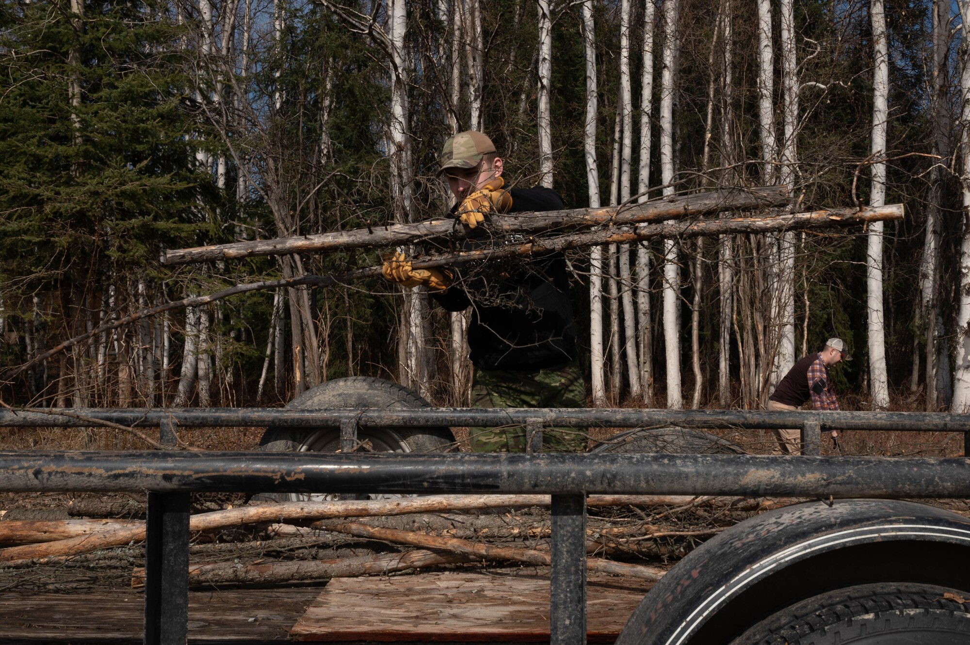 U.S. Air Force Airman 1st Class Luke Scampone, 354th Munitions Support Squadron armament systems journeyman, cleans up branches as a volunteer for the Sportsman’s Wingmen program at Eielson Air Force Base, Alaska, May 1, 2024.