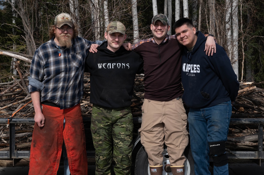 Volunteers from the Sportsman’s Wingmen program pose for a group photo after cleaning up tree branches at Eielson Air Force Base, Alaska, May 1, 2024.