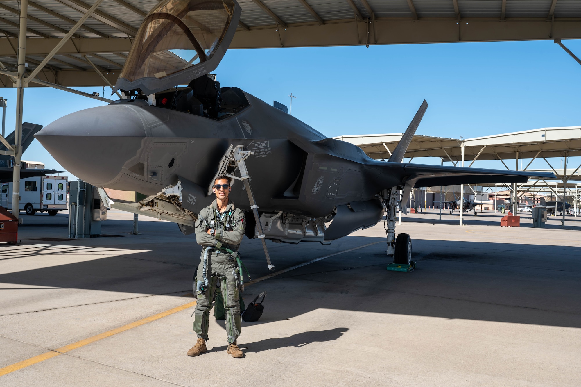 U.S. Air Force Capt. Garrett Ellis, 308th Fighter Squadron instructor pilot, poses in front of an F-35 Lightning II before conducting the 100,000th F-35 sortie at Luke Air Force Base, Arizona, May 9, 2024.