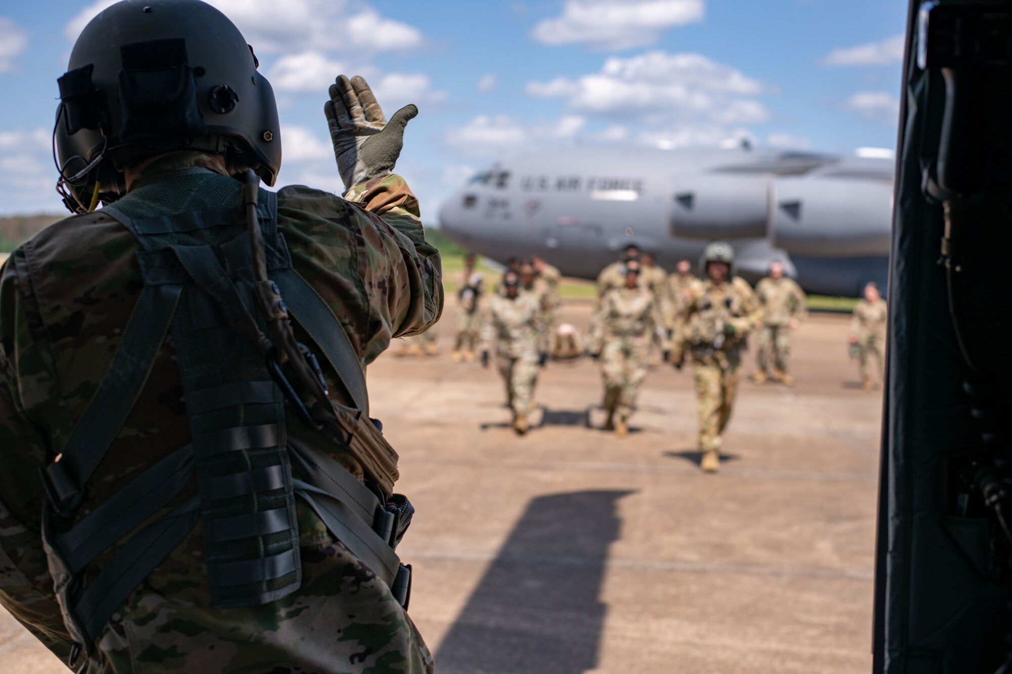 U.S. Army National Guard Soldiers gesture for Airmen from the 172nd Medical Group and 183rd Aeromedical Evacuation Squadron to bring simulated patient to be loaded on the Mississippi UH-60 Black Hawk for Operation Vital Force in Jackson, Mississippi, May 4, 2024. Operation Vital Force is a training exercise designed to evaluate the capabilities of Airmen when responding to natural disasters, aeromedical evacuation, casualty care and mortuary affairs. (U.S. Air National Guard photo by Airman 1st Class Damara Cormier)