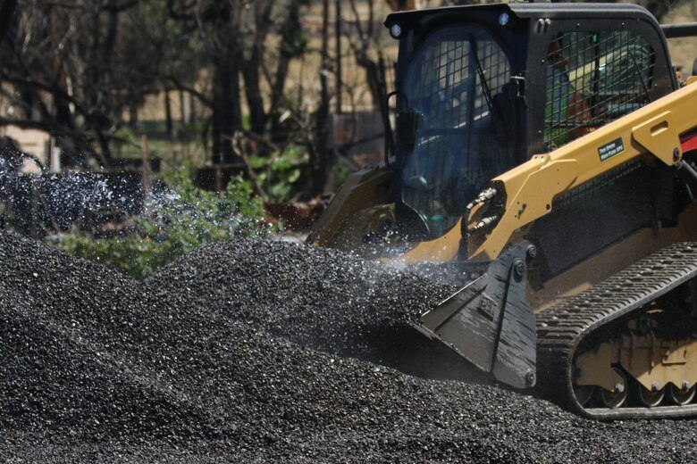 A U.S. Army Corps of Engineers contractor places erosion control materials on a cleared property during Phase 2 debris removal operations April 05 in Lahaina, Hawaii.  Erosion control is used for soil stabilization and is the last step in the debris removal process before right of entry is relinquished back to the County of Maui.