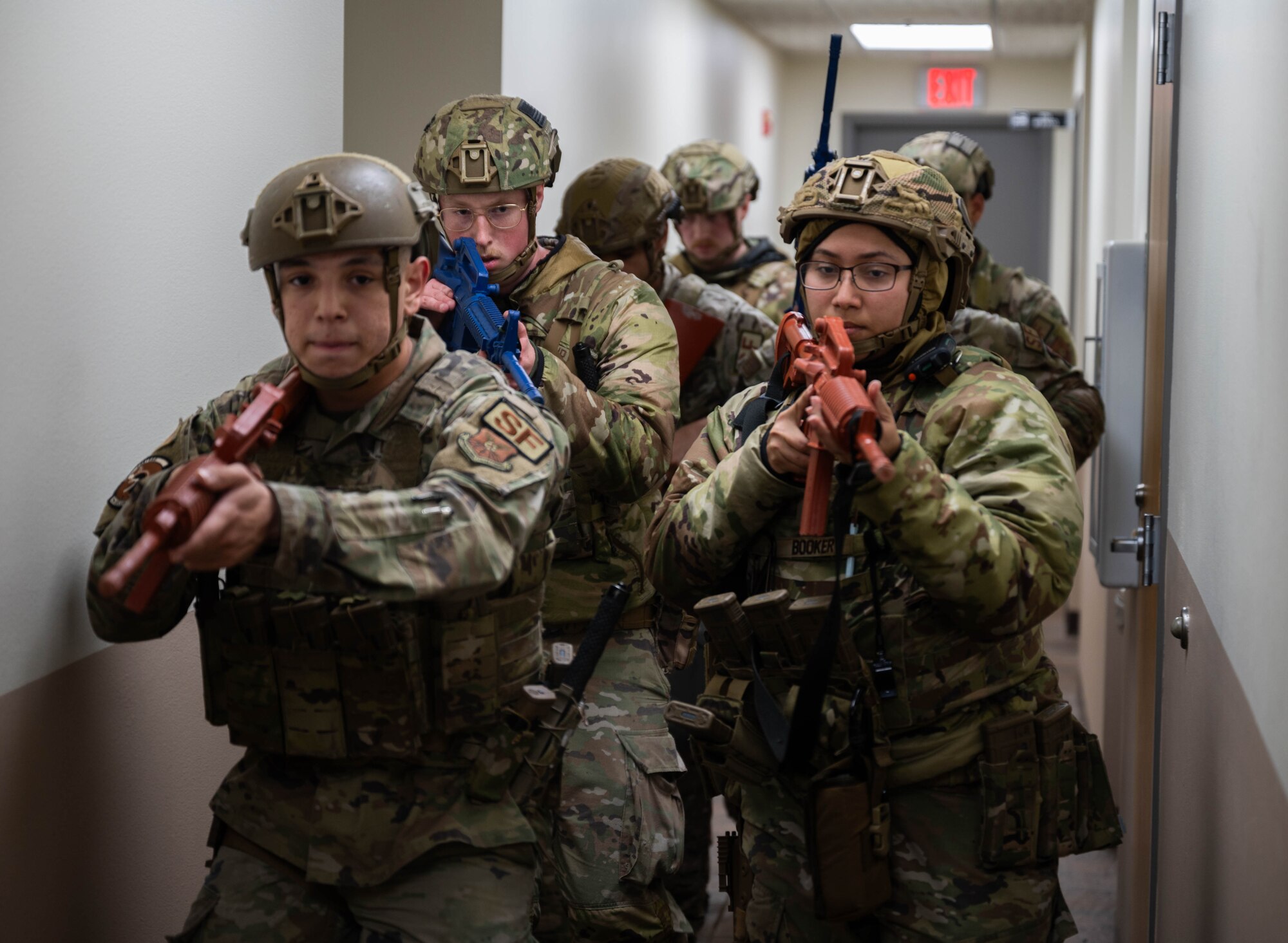 Defenders assigned to the 5th Security Forces Squadron (5th SFS) patrol a building as part of an active shooter drill during Warbird Week at Minot Air Force Base, North Dakota, May 7, 2024. Warbird Week is an exercise that tests the overall capabilities of the 5th Bomb Wing units and how effectively they perform their missions. (U.S. Air Force photo by Airman 1st Class Luis Gomez)