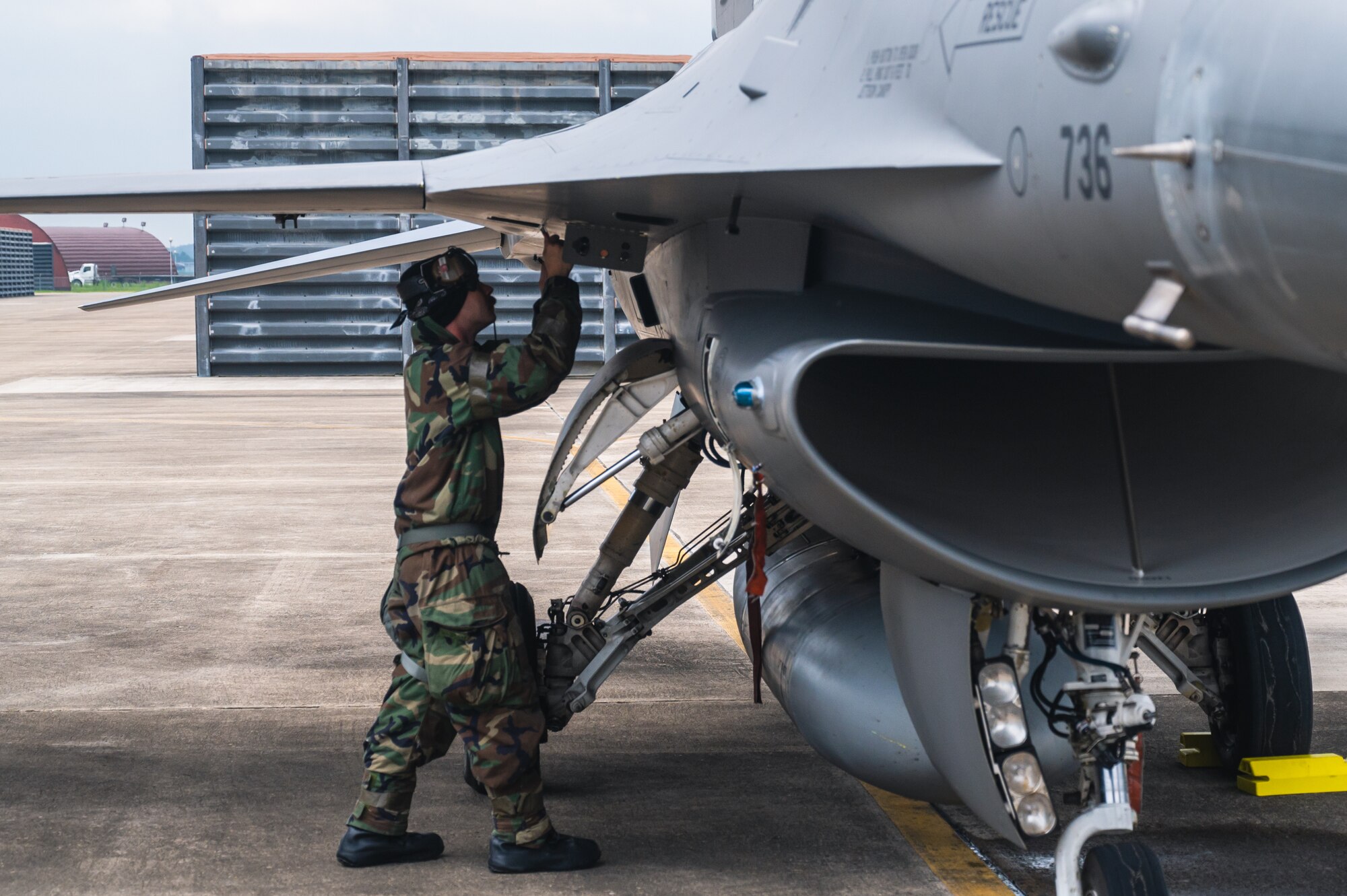 Staff Sgt. Damon Nugent inspect an F-16 Fighting Falcon.