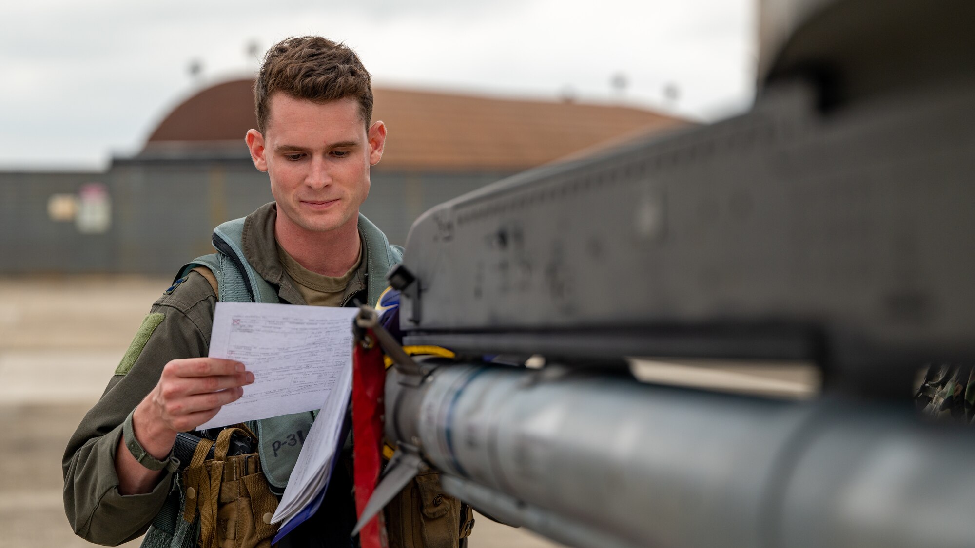Capt. Ryan Woodall reviews the work done on an F-16 Fighting Falcon.