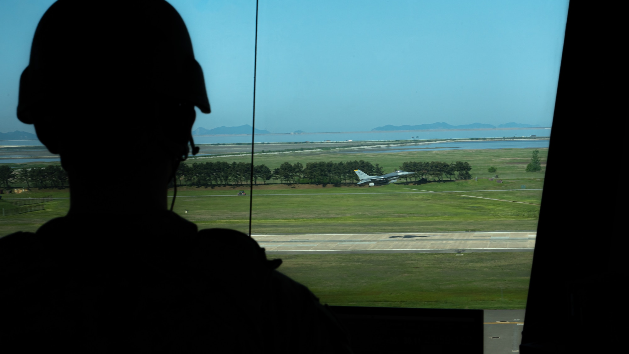 A member of the 8th Operation Support Squadron watches from the air traffic control tower as an F-16 Fighting Falcon takes off.