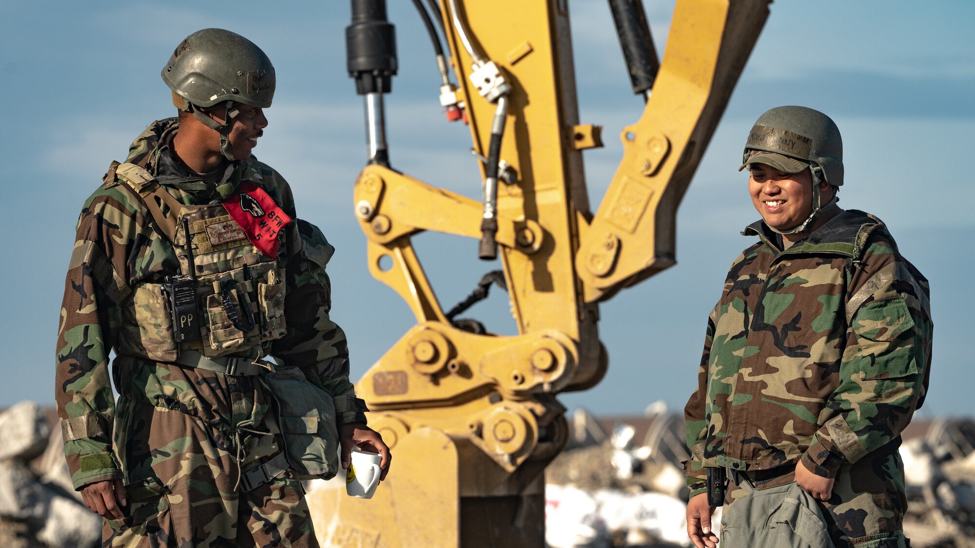 Technical Sgt. Richardson Marquette and Senior Airman Danny Morta talk during a rapid airfield damage repair training.